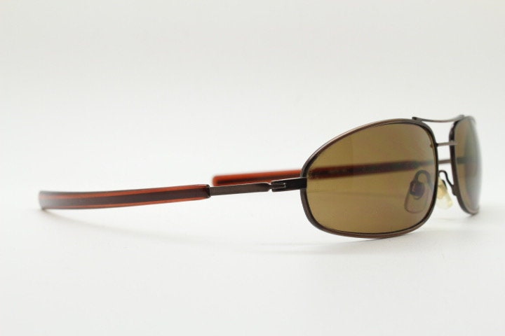 90s vintage abstract rectangular sunglasses. Metallic bronze satin finish frame with brown lenses and straight arms. 2000's. NOS aviator