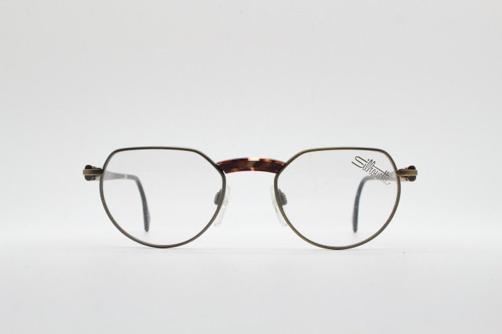 Silhouette vintage 90s flat top oval eye glasses made in Austria. Satin bronze optical frame with honey tortoise trim. Prescription RX