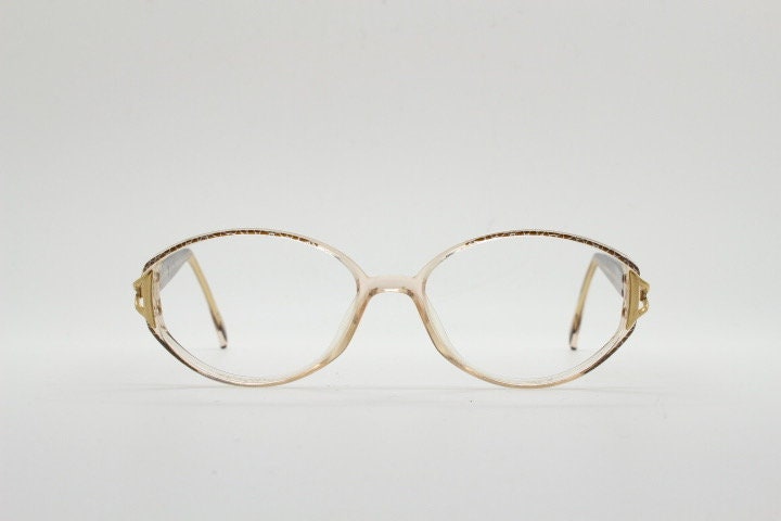 Silhouette 80s vintage oval eye glasses made in Austria. Transparent crystal optical frame with giraffe arm print. Prescription RX