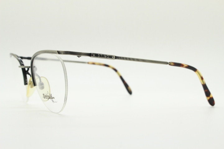 Sting 90s vintage round eye glasses. Minimal pewter finish metal half frame brow line optical frames. Prescription eyeglasses. RX. NOS