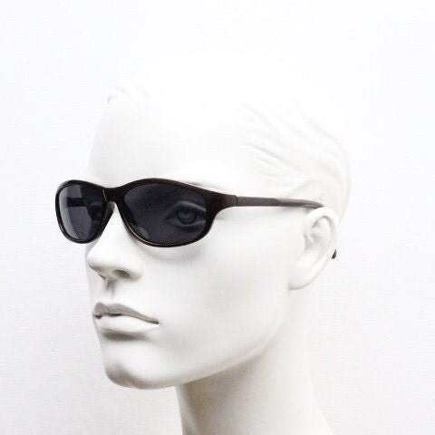 Y2K vintage wrap around shield sunglasses. Brown aerodynamic high gloss frame with black curved lenses. 2000's sport. New Old Stock 90s