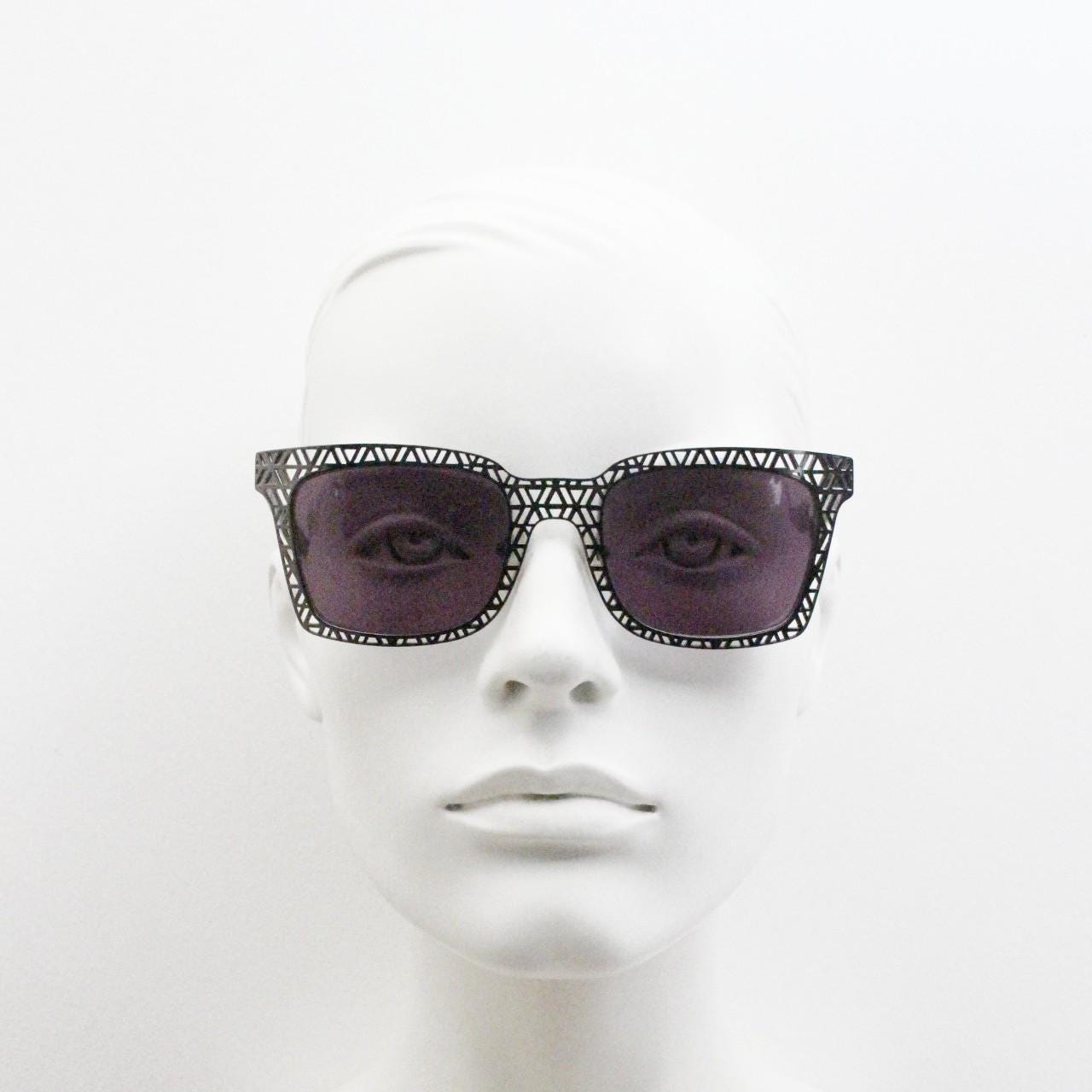 Sass and bide vintage wayfarer shape sunglasses. Gunmetal grey flat metal frame with cut out patterns throughout and black lenses. 2000s NOS