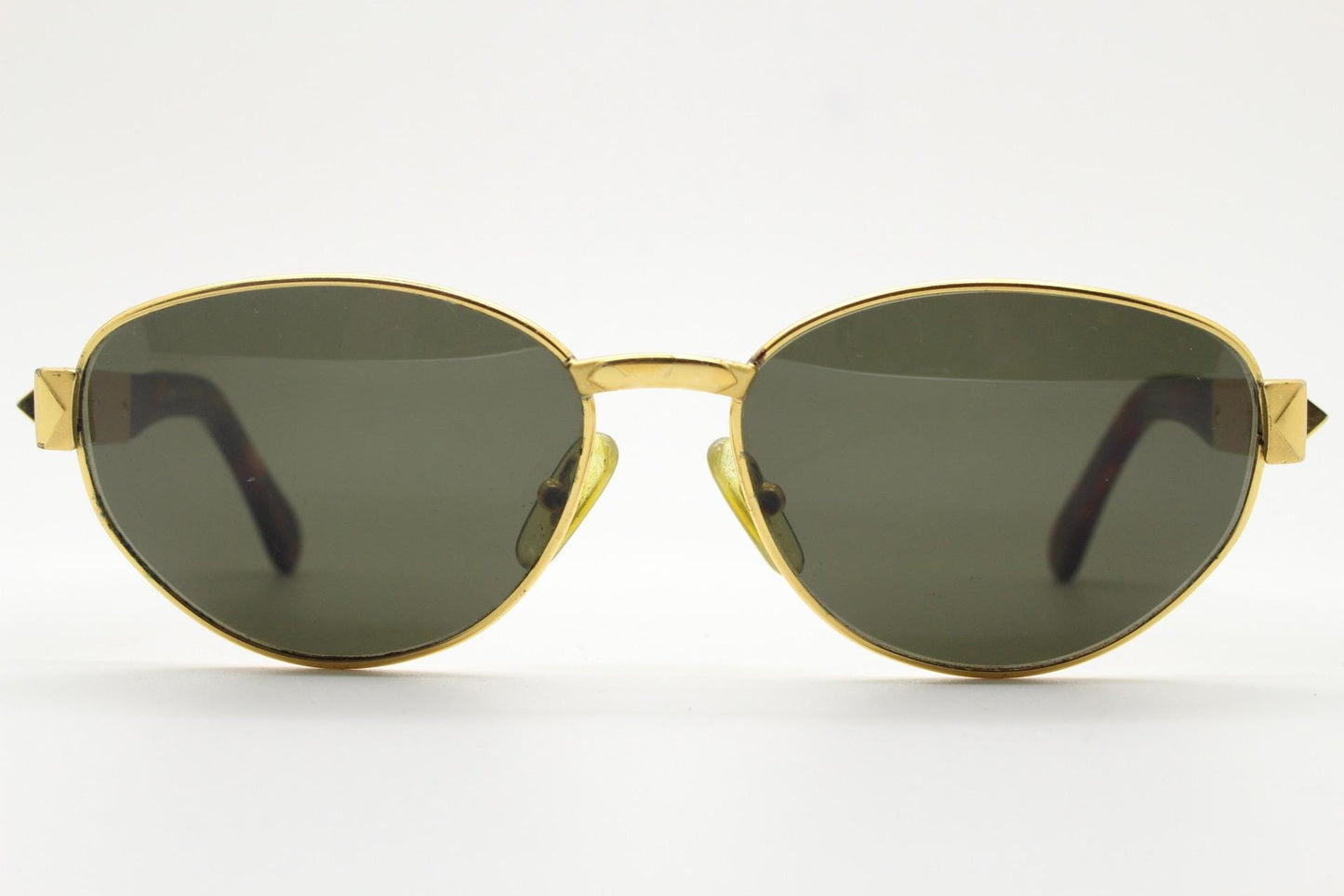 Gianfranco Ferre oval sunglasses made in Italy. Gold frame with triangular tortoise acetate arms and green lenses. 90s vintage GFF