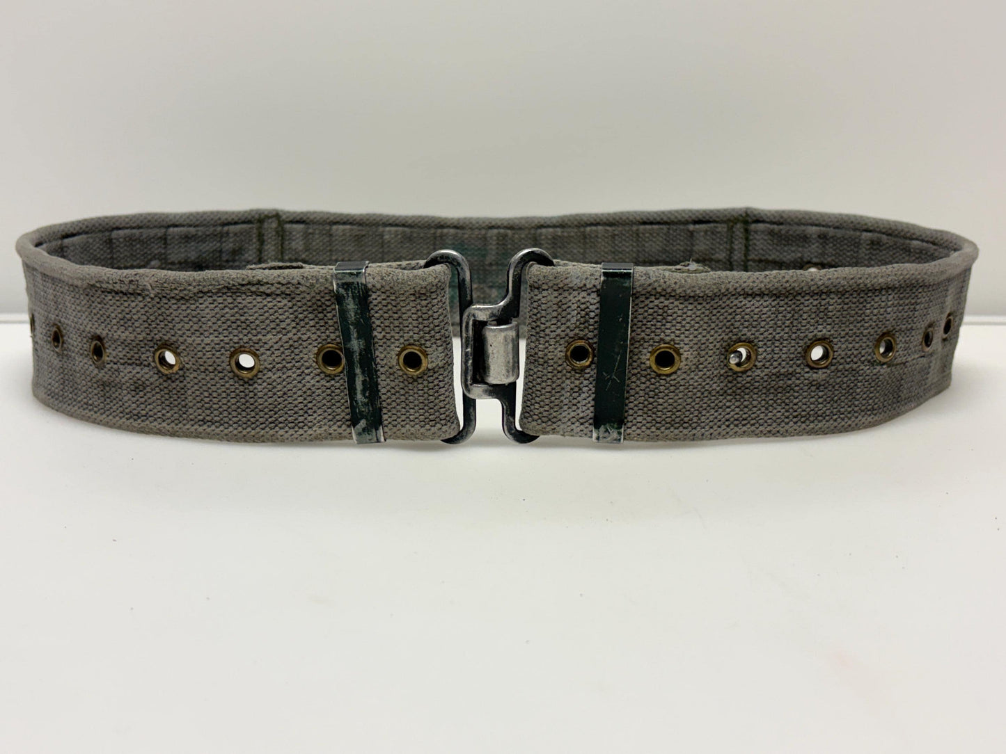 80s vintage real army webbing belt. Thick woven canvas in khaki green. Distressed look. Metal hardware. Fully adjustable. Tactical webbing