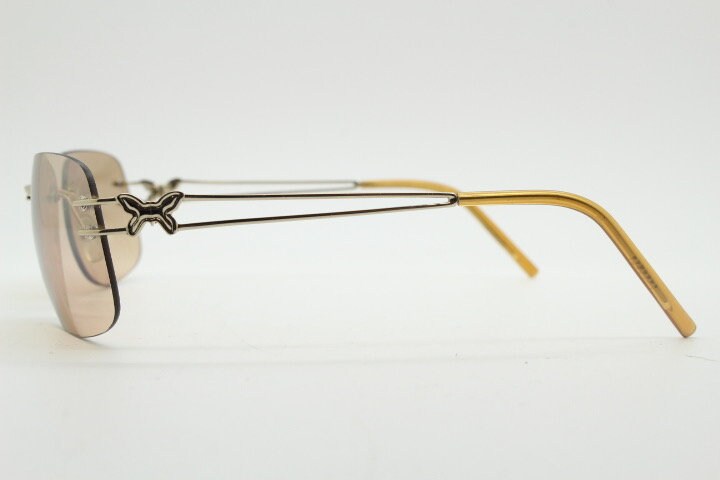 Y2K vintage rimless rectangular sunglasses. Frameless 2000's brown lens with slight mirror glaze gold trim and butterfly hinges. 00's NOS