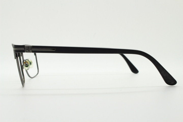 Calvin Klein rectangular eye glasses. Gunmetal grey chrome wire optical frames with black matt brow. Prescription eyeglasses. RX Spectacles