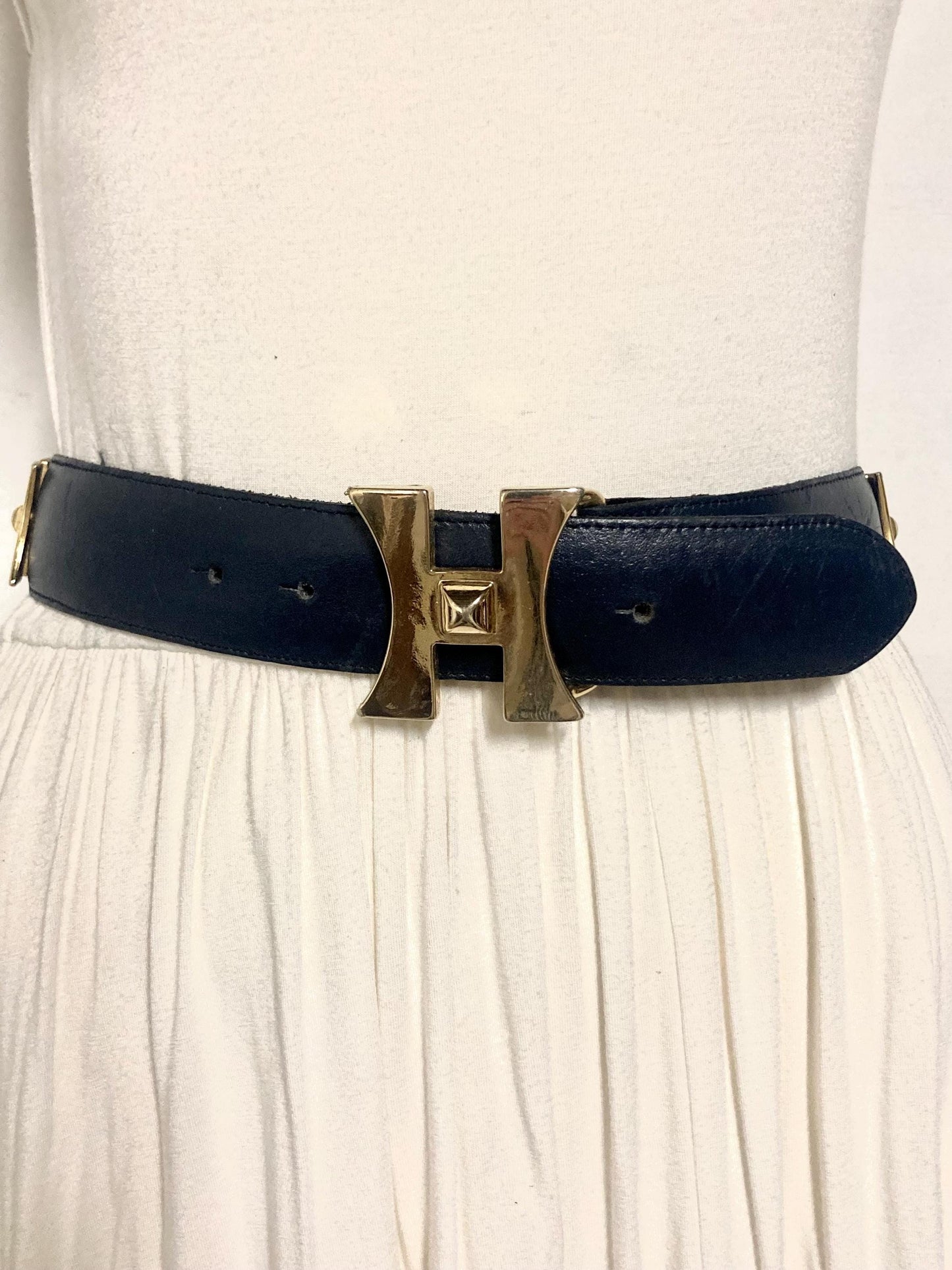 80s vintage womens dress belt in navy blue genuine leather with substantial gold chrome studded 'H' motifs. Made in France. Size S