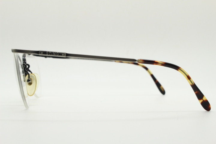 Sting 90s vintage round eye glasses. Minimal pewter finish metal half frame brow line optical frames. Prescription eyeglasses. RX. NOS