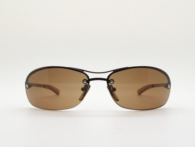 Y2K vintage oval aviator sunglasses. Metallic brown chrome half frame with mid tone curved bug eye lenses and straight arms. 2000's. NOS