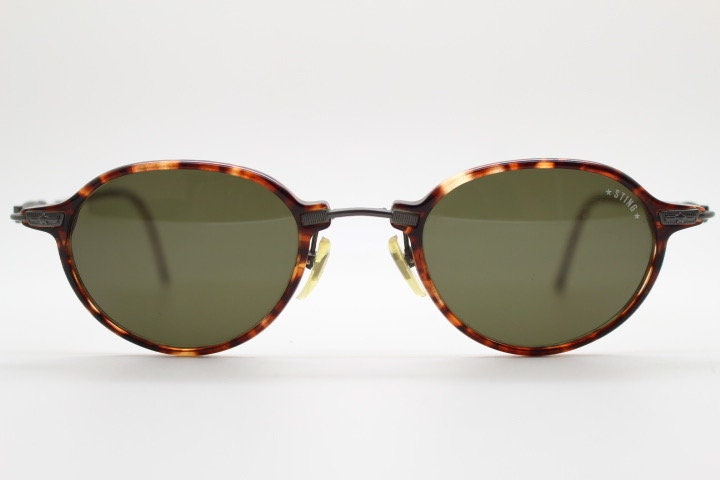 Sting 90s vintage oval sunglasses made in Italy. Refined 'industrial tech' fused with 1930s style in bronze metal and tortoise . Unused NOS