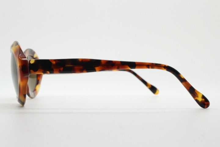 Francois Pinton Paris 90s vintage oval sunglasses made in France. Womens thick acetate frame in brown and amber tones. NOS
