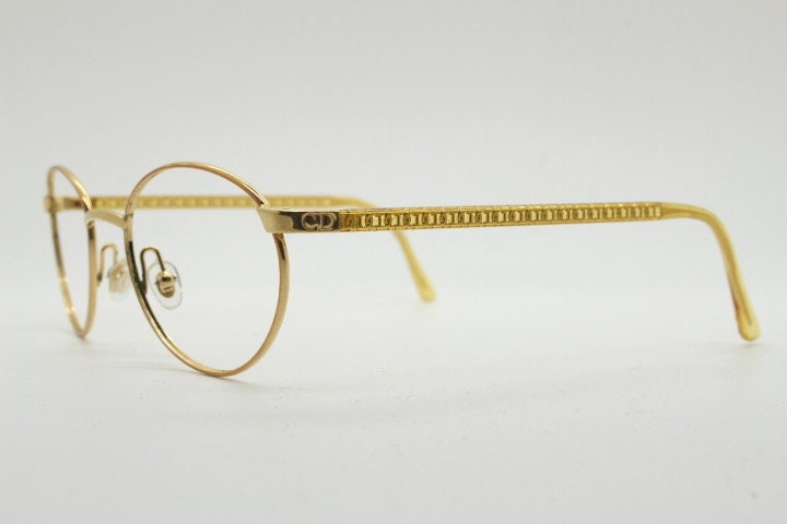 Christian Dior 90s vintage oval eye glasses made in Austria. Lustrous gold finish optical frame with CD chain link arms. Prescription RX NOS
