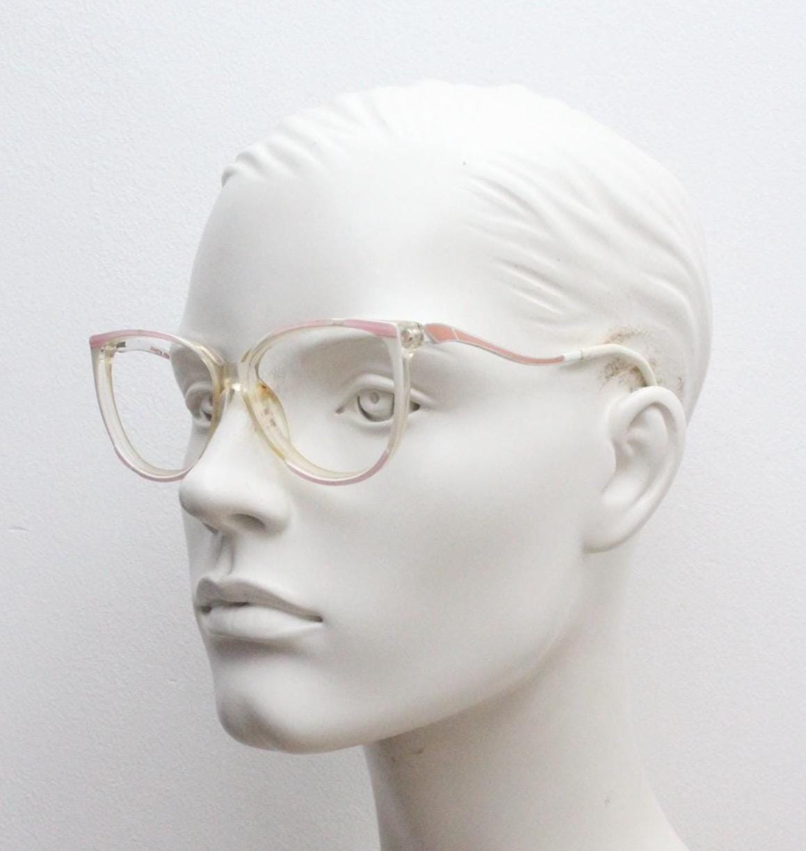 Invicta 80s vintage oversized cat eye glasses made in England. Ice white and pink acetate prescription optical frame with undulating arms