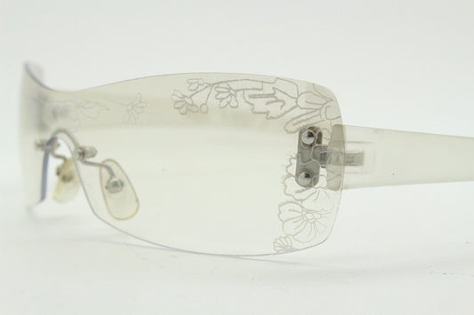 Y2K vintage visor sunglasses. Frameless 2000's wraparound mini mask shield design with light tone mirror mono lens and flower print. 00s NOS