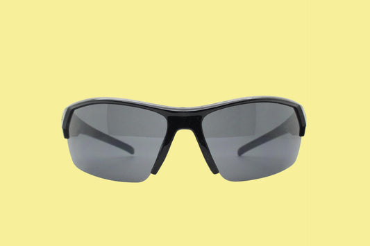 A pair of black sunglasses with dark lenses is shown against a yellow background.