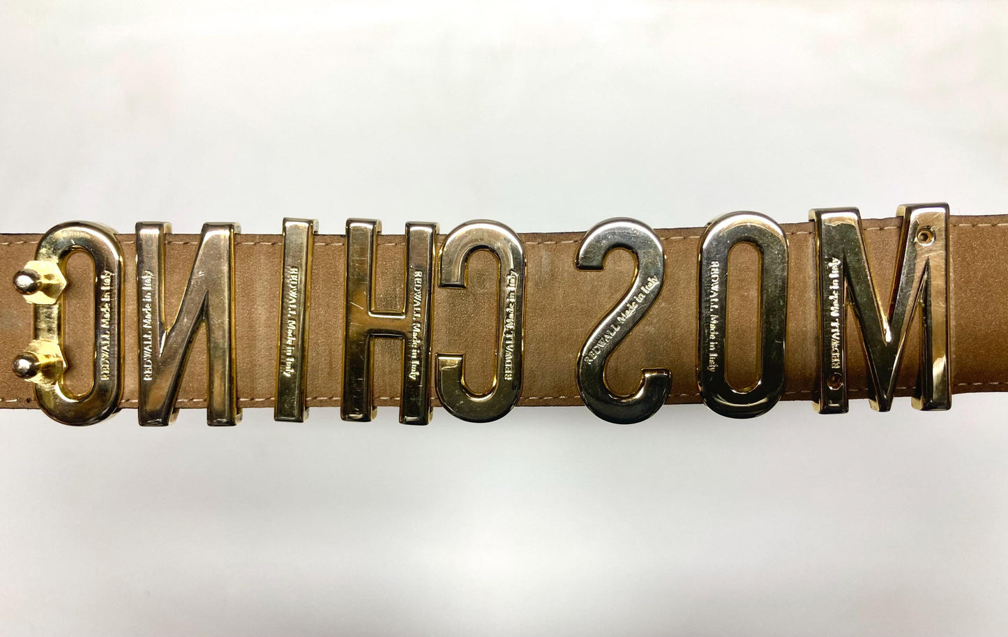 Moschino 90s vintage womens dress belt in black genuine leather. Iconic individual golden moving letters logo. Made in Italy. 80s. NOS