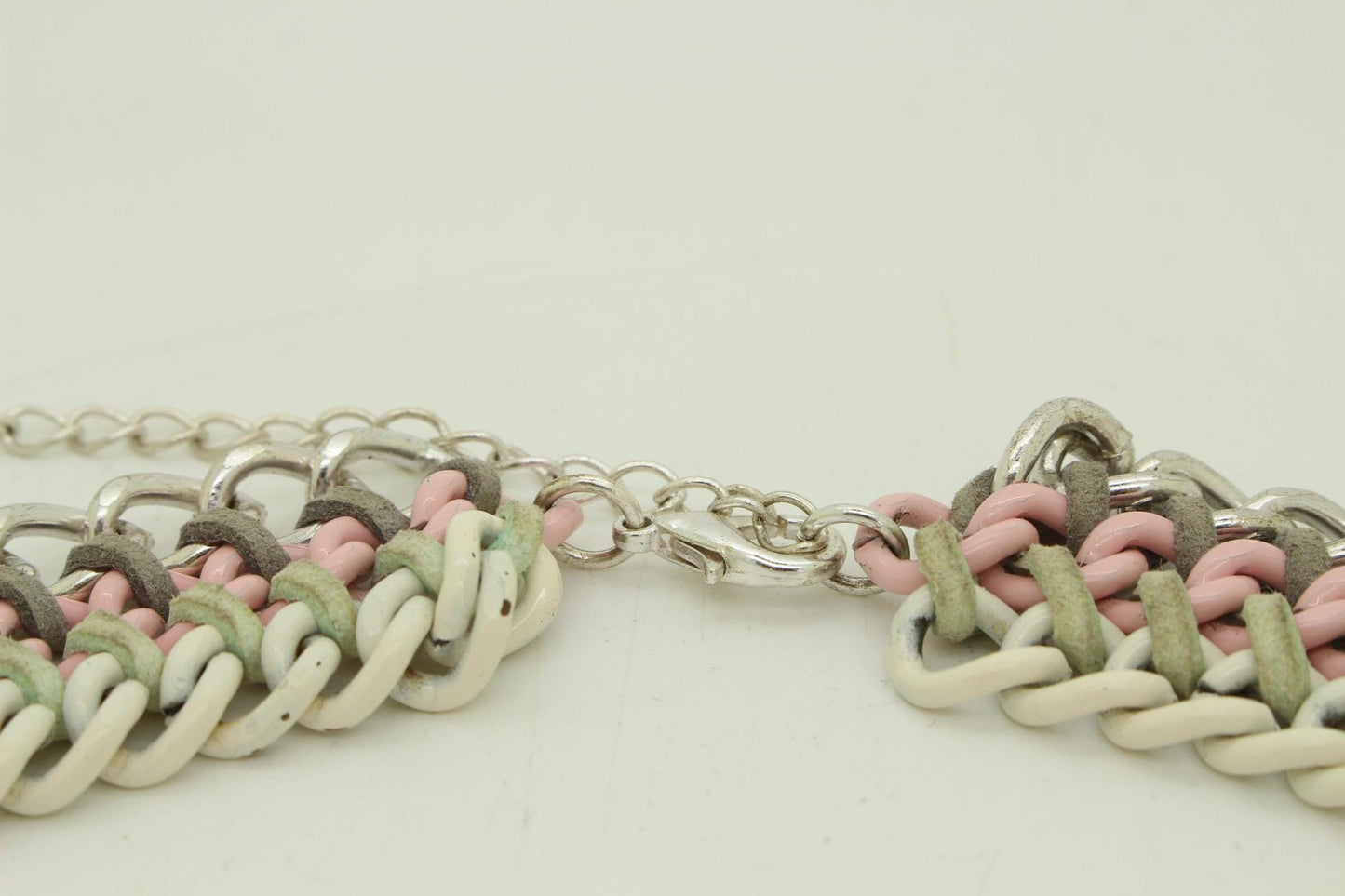 90s vintage 3 tier chain necklace. Solid metal construction in silver, pink, and white tones with grey rubber bonds. Adjustable back