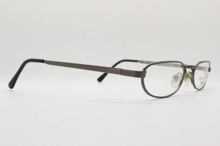 Alberta Ferretti 90s vintage oval eye glasses made in Italy. Small grey metal optical frame with ornate arm pattern. Prescription RX. NOS
