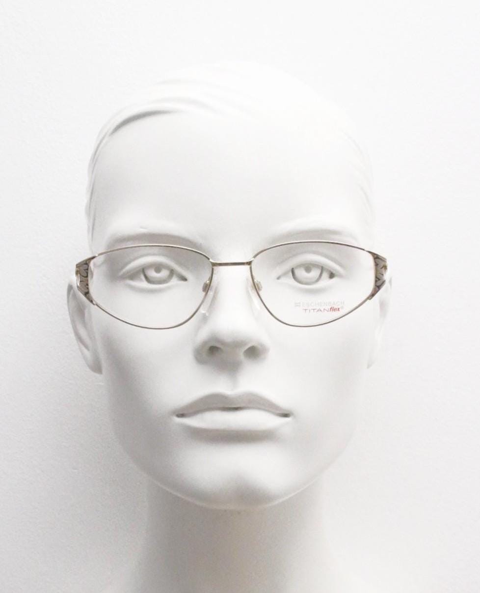 Eschenbach 90s vintage cropped cat eye glasses. Low profile gold metal optical frame with tasteful metallic arm pattern. Prescription. NOS