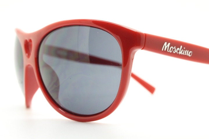 Moschino oversized Y2K vintage sunglasses. Characteristic crimson red acetate frame with cut out heart bridge. 2000s