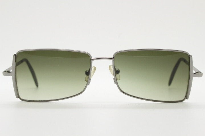 Exte rectangular 90s vintage sunglasses made in Italy. Grey chrome low profile frame with graduating green lenses