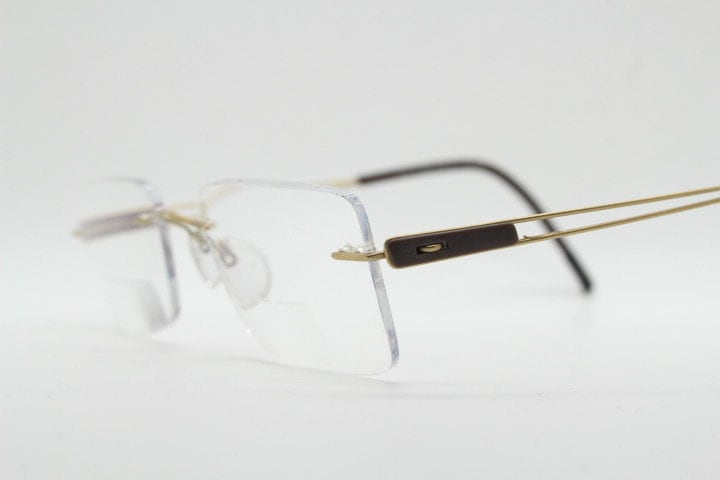 Silhouette rectangular frameless eye glasses model 7677 made in Austria. Minimal lightweight optical frame with golden trim. Prescription RX