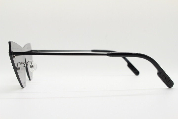 Kenzo flat screen triangular futuristic cat eye. Slight mirror glaze mono lens on black matt metal wire frame. NOS Cateye