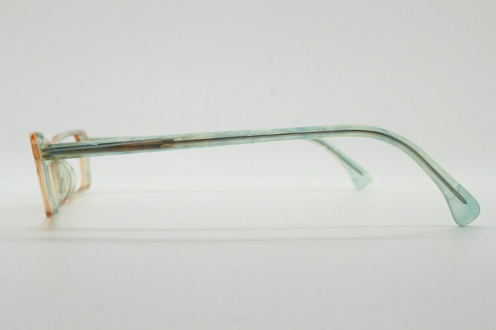 Alain Mikli rectangular eye glasses hand made in France. Low profile slim peach and blue transparent acetate optical frame. Prescription RX.