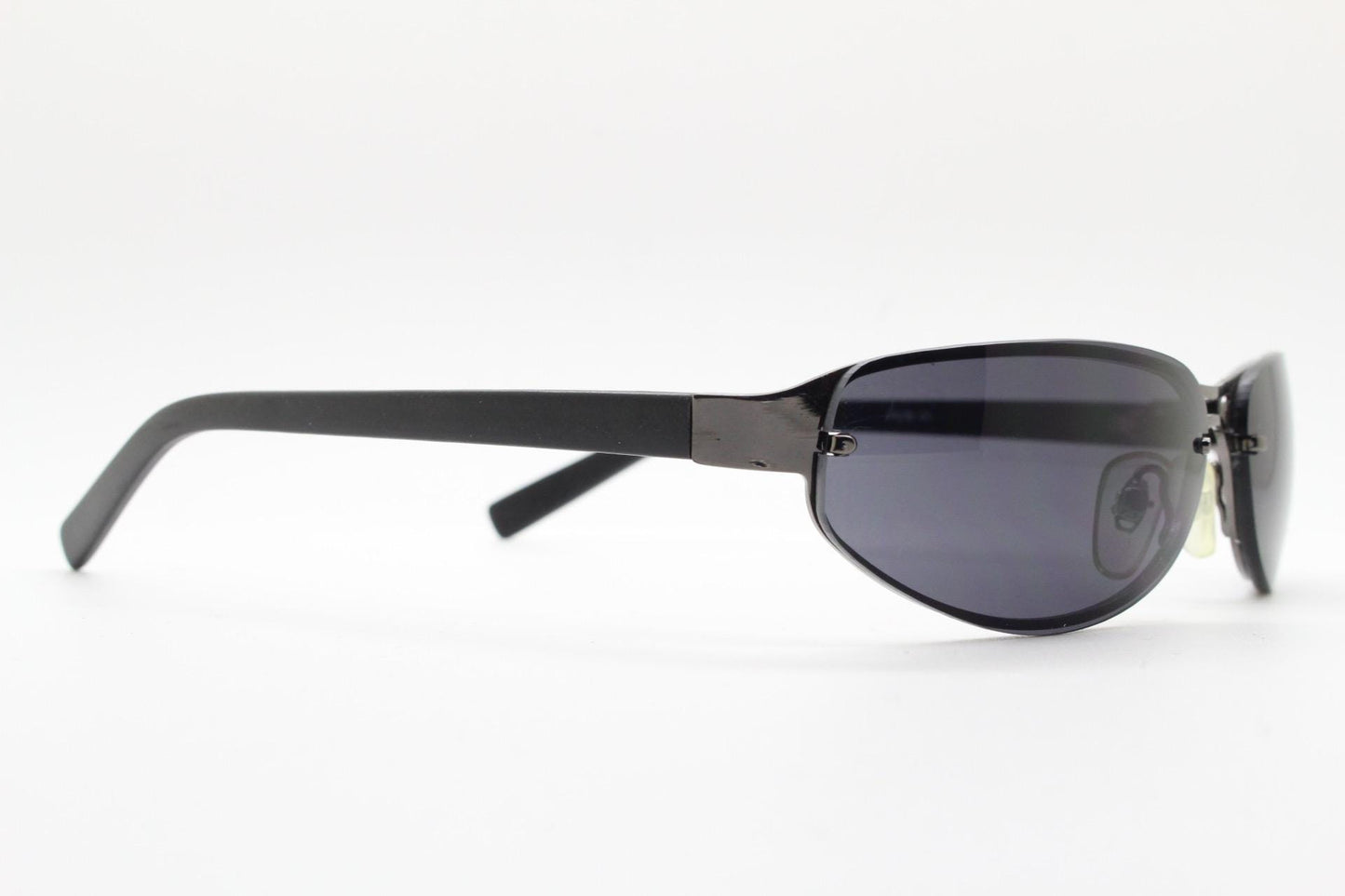 Y2K vintage small bug eye oval sunglasses. Gunmetal grey chrome metal frame with curved bug eye lenses and matt black arms. 2000's NOS