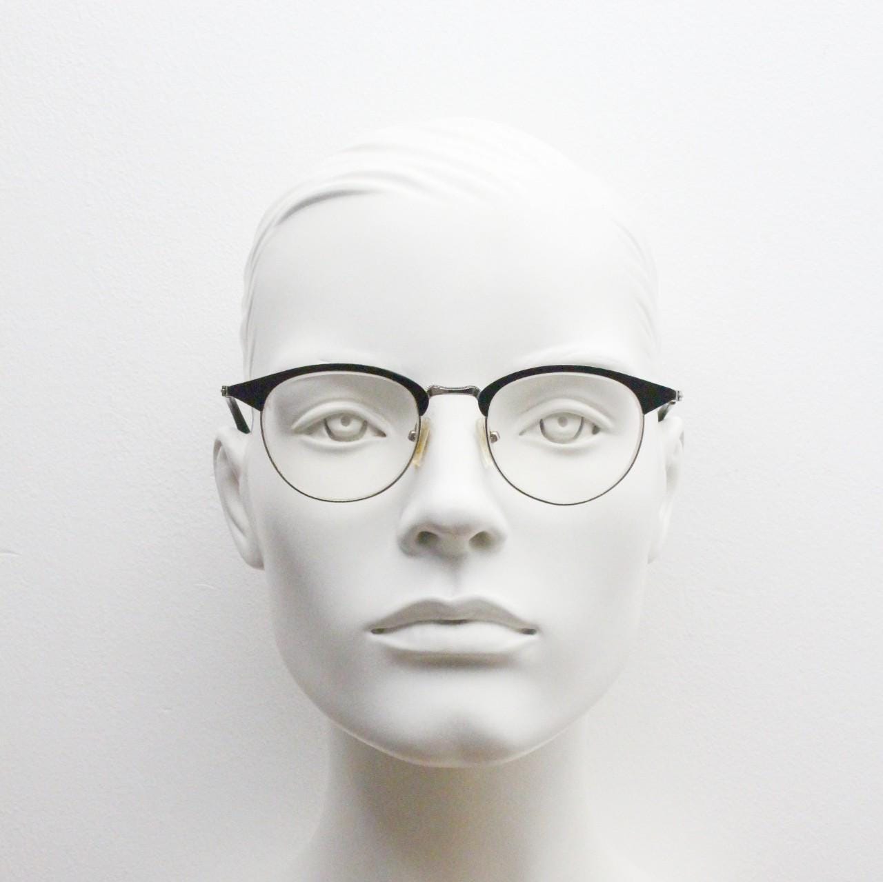 Lupo and Co round eye glasses with pointed corners. Flat metal silver optical frames with black browline. Prescription eyeglasses. RX