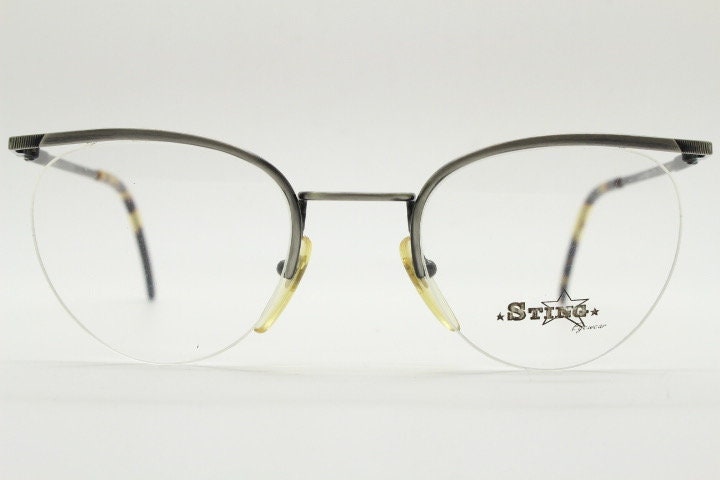 Sting 90s vintage round eye glasses. Minimal pewter finish metal half frame brow line optical frames. Prescription eyeglasses. RX. NOS