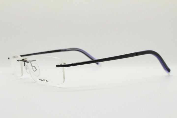 Police 90s vintage rectangular frameless eye glasses made in Italy. Minimal low profile optical frame with black satin metal trim. RX