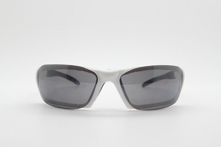 Y2K vintage visor sunglasses. Black and white superhero style sport shield with curved black lenses. Aerodynamic wrap around. NOS rave