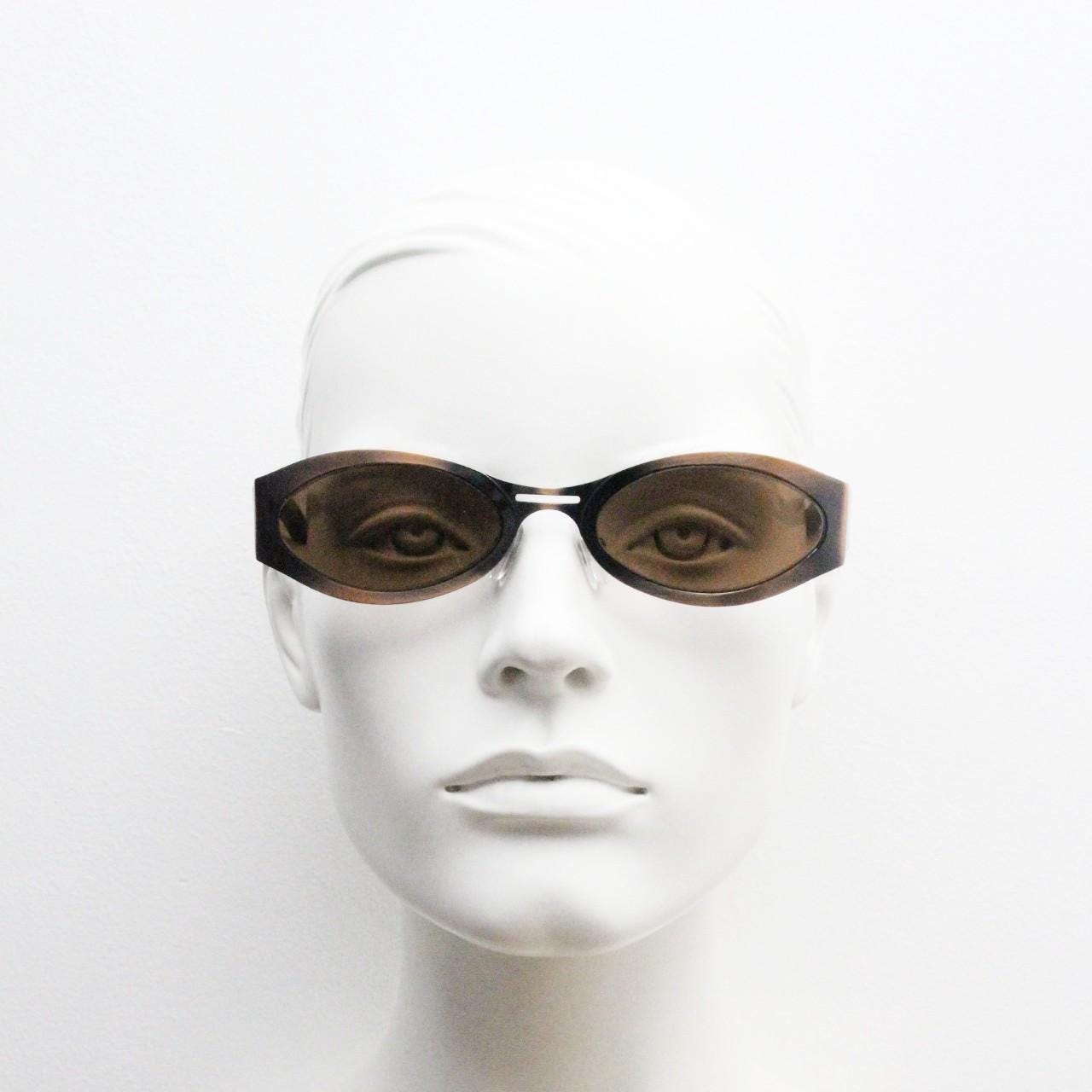 2000s vintage wraparound angular sunglasses. brushed copper finish flat curved metal frame with cut out arms. 90s. Y2K unused NOS