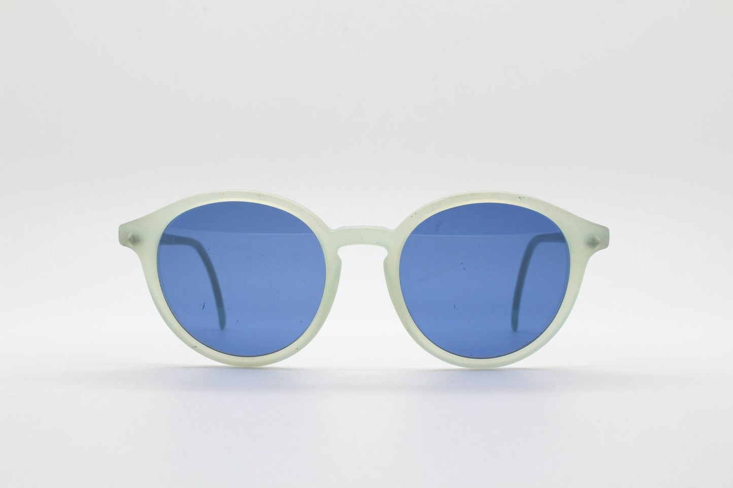 Sergio Tacchini 80s vintage round horn rim sunglasses made in Italy. Transparent pale blue frosted acetate frame with navy lenses. NOS