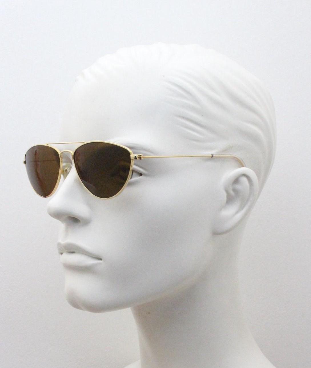 90s vintage minimal triangular sunglasses. Slim gold frame with plain brown lenses. Small modified aviator design. NOS