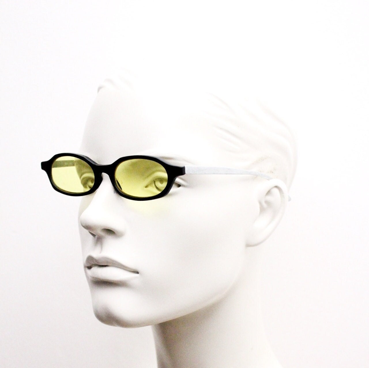 Vintage 90s oval sunglasses. Black low profile matt finish front with yellow lenses and silver chrome arms. Micro
