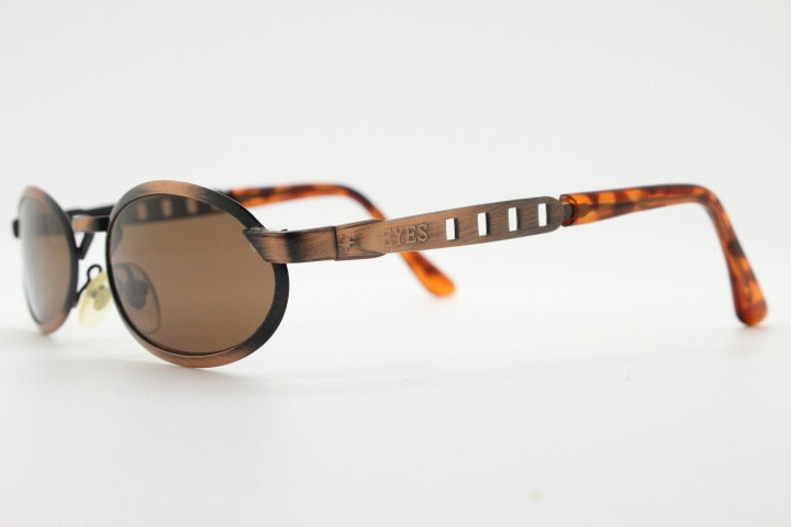 90s vintage oval sunglasses. Handsome metallic brushed copper finish with arm cut outs. Unused NOS