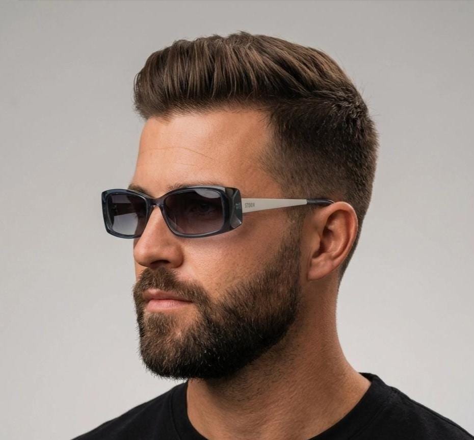 90s vintage rectangular low profile sunglasses by Storm. Transparent grey acetate front with brushed steel arms. NOS. 2000s