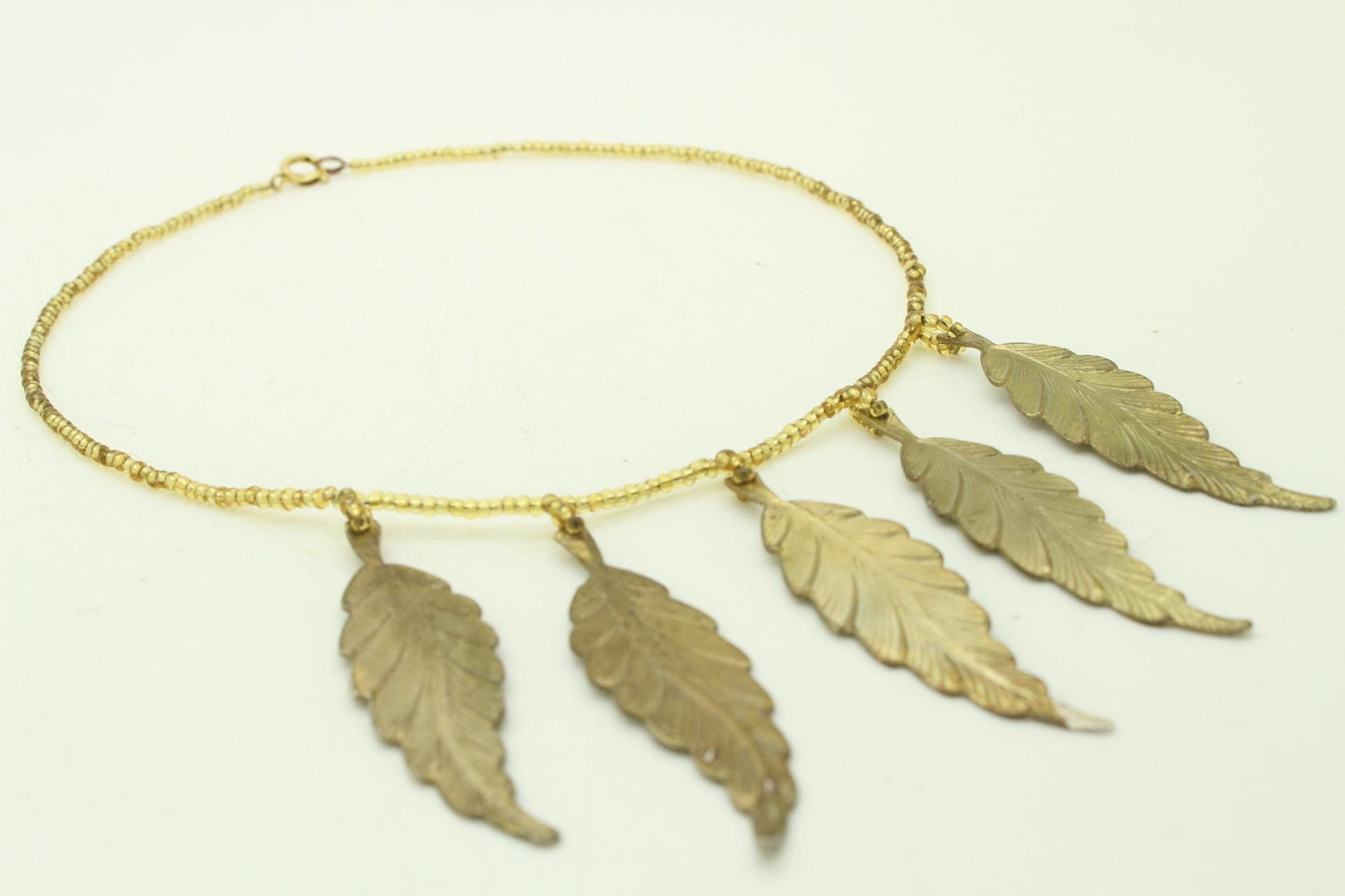 80s vintage gold beaded necklace with large dangling leaves . Charming statement piece. Country and western. Native american