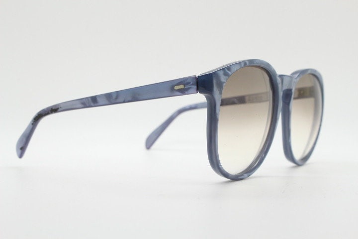 Michele L'Amy 80s vintage round sunglasses made in France. Lustrous marbled blue frame with keyhole bridge and graduating brown lenses