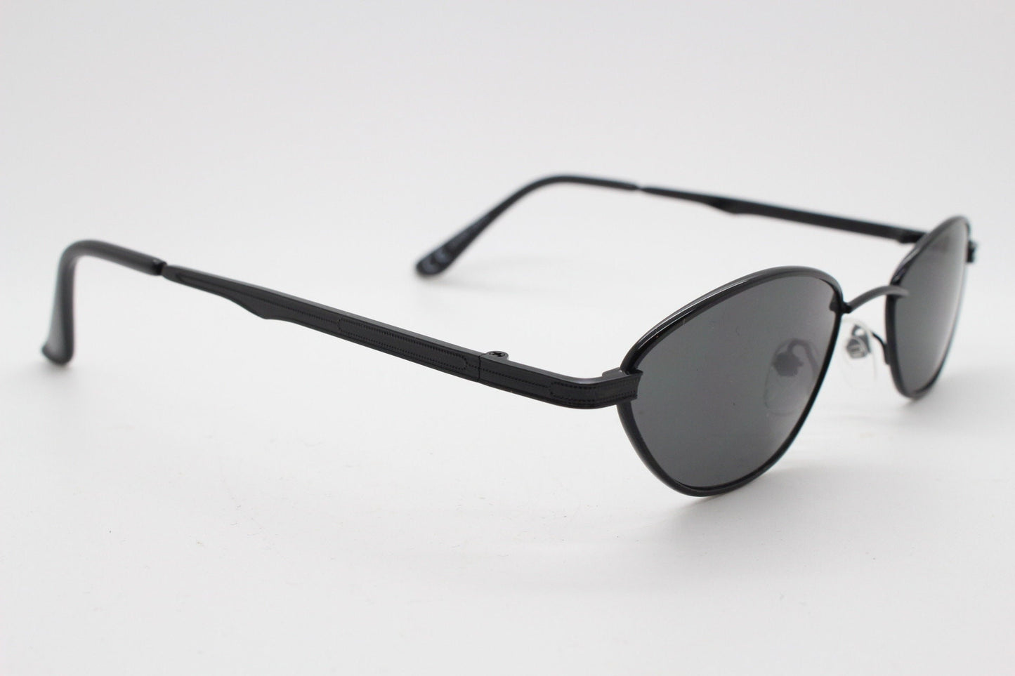 90s vintage low profile sunglasses. Minimal small black angular oval metal frame with matching lenses, Unused. BNWT