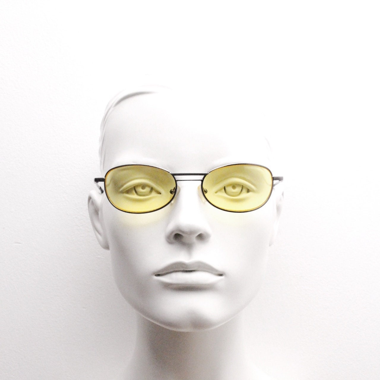 Y2K vintage small oval bug eye sunglasses. Gunmetal grey satin finish frame with blazing canary yellow lenses. Unused 2000s NOS. 90s micro