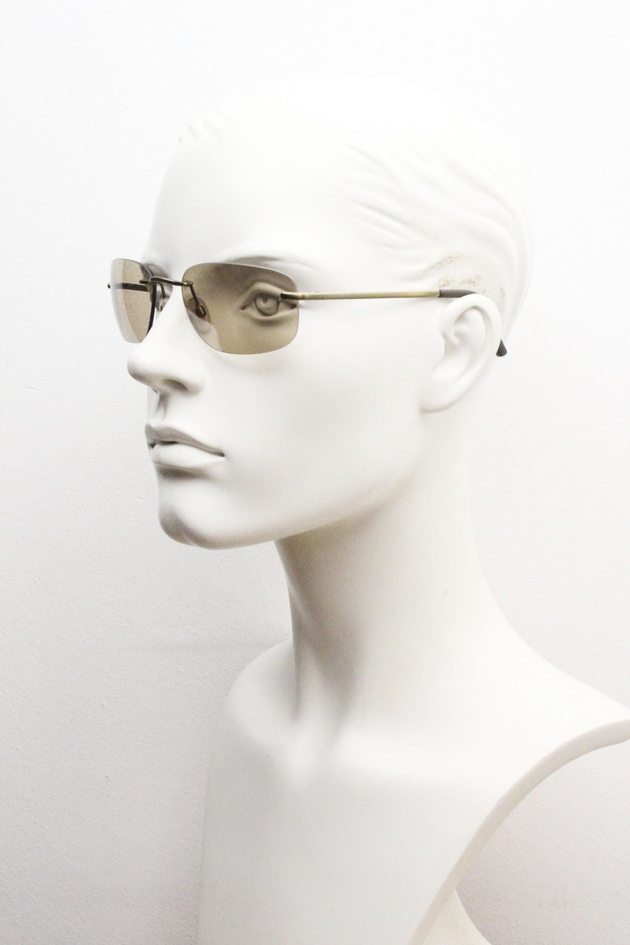 Ben Sherman 90s vintage frameless sunglasses. Minimal brown rectangular lens with brown chrome trim in neat proportions. Mens Mod shades