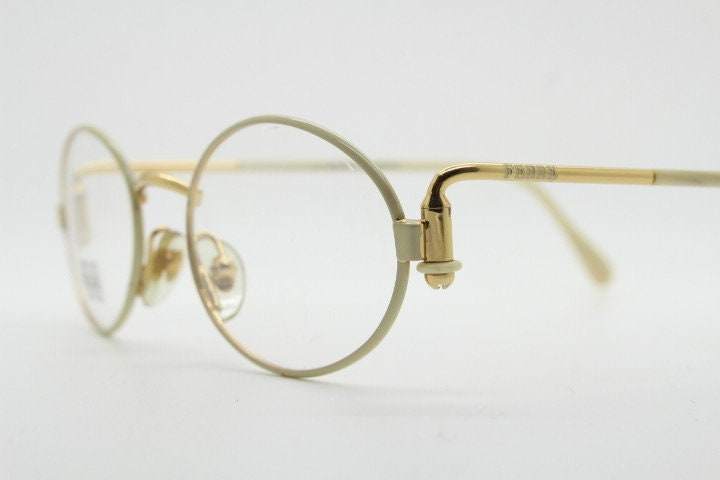 Gianfranco Ferre 90s vintage oval eye glasses made in Italy. White and gold metal tech design optical frame. Prescription RX spectacles. NOS