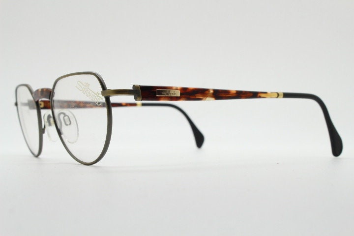 Silhouette vintage 90s flat top oval eye glasses made in Austria. Satin bronze optical frame with honey tortoise trim. Prescription RX