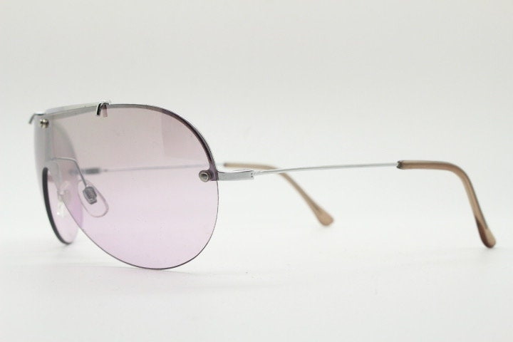 Y2K vintage visor shield sunglasses. Silver chrome half frame with pink wraparound mono lens and mirror glaze. Mini mask. 00's. 2000's NOS