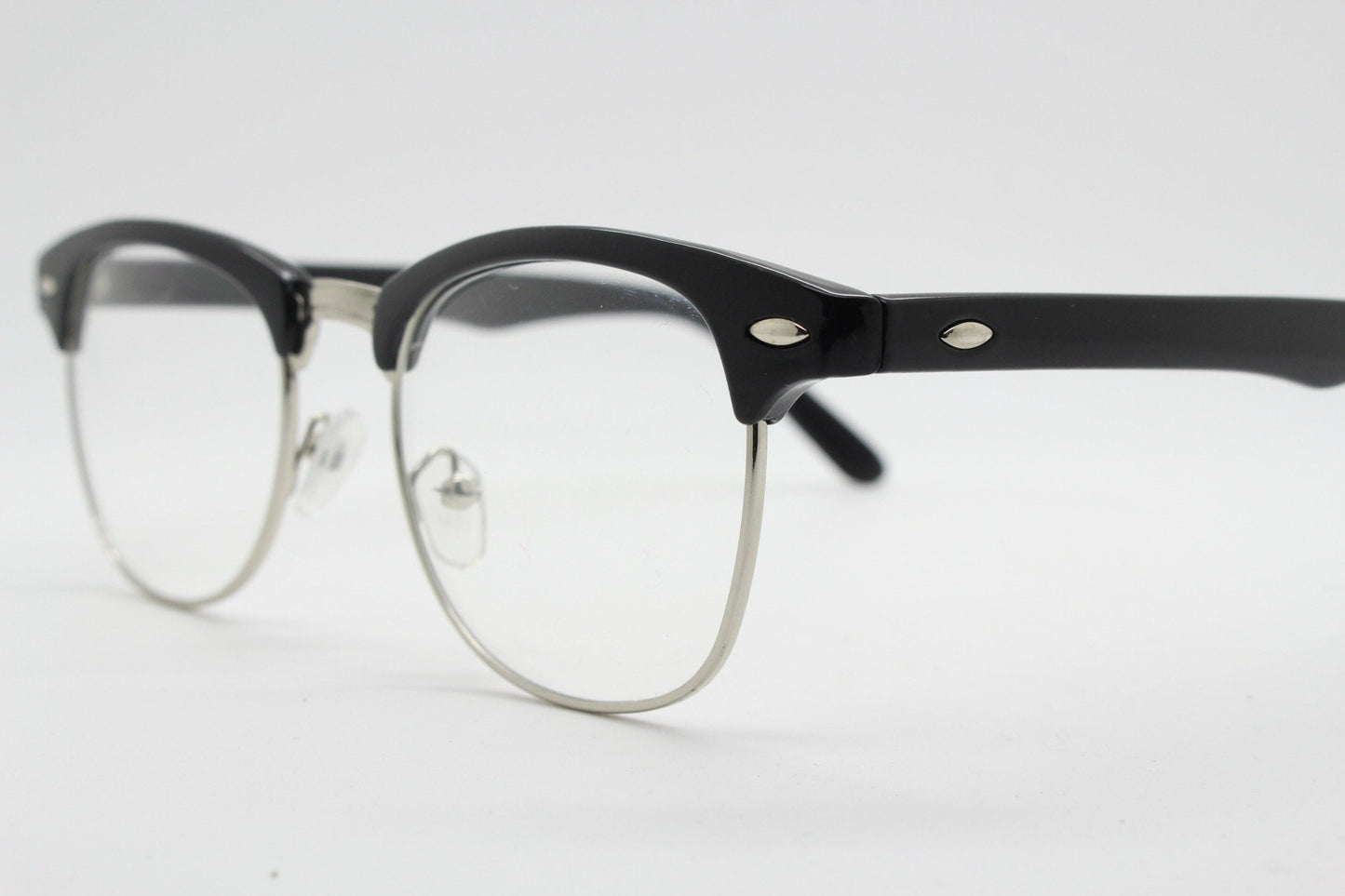 90s vintage black half frame eye glasses. Black gloss browline with silver wire rim frame and clear lenses. Classic 50s, 60s design. NOS