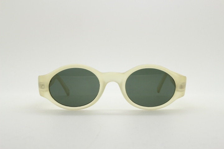 Vintage 90s oval transparent sunglasses. Frosted frame with dark green lenses and heart shaped chain link arms. Unworn NOS