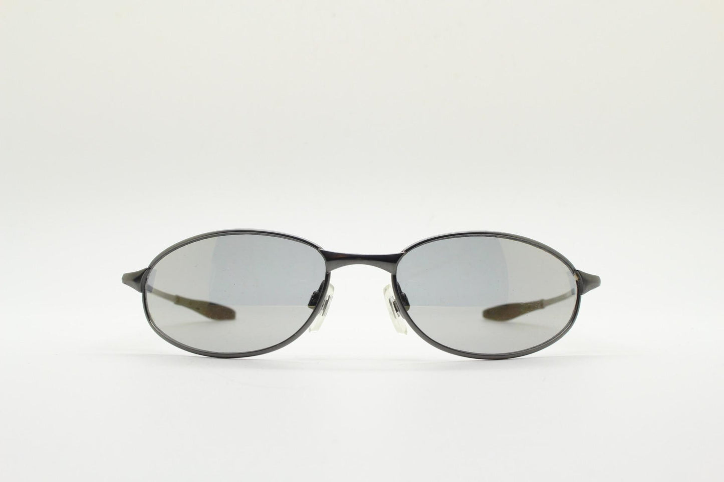 90s vintage oval small  bug eye sunglasses. Satin finish frame in gunmetal with straight spear arms. Y2K. 2000s. Unworn NOS